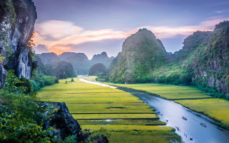 Ninh Binh offers limestone mountains, rice fields, and tranquil river journeys.